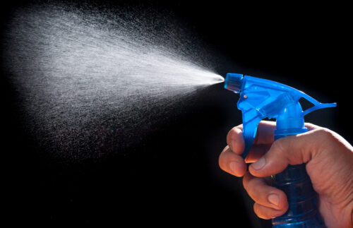 holding spray bottle